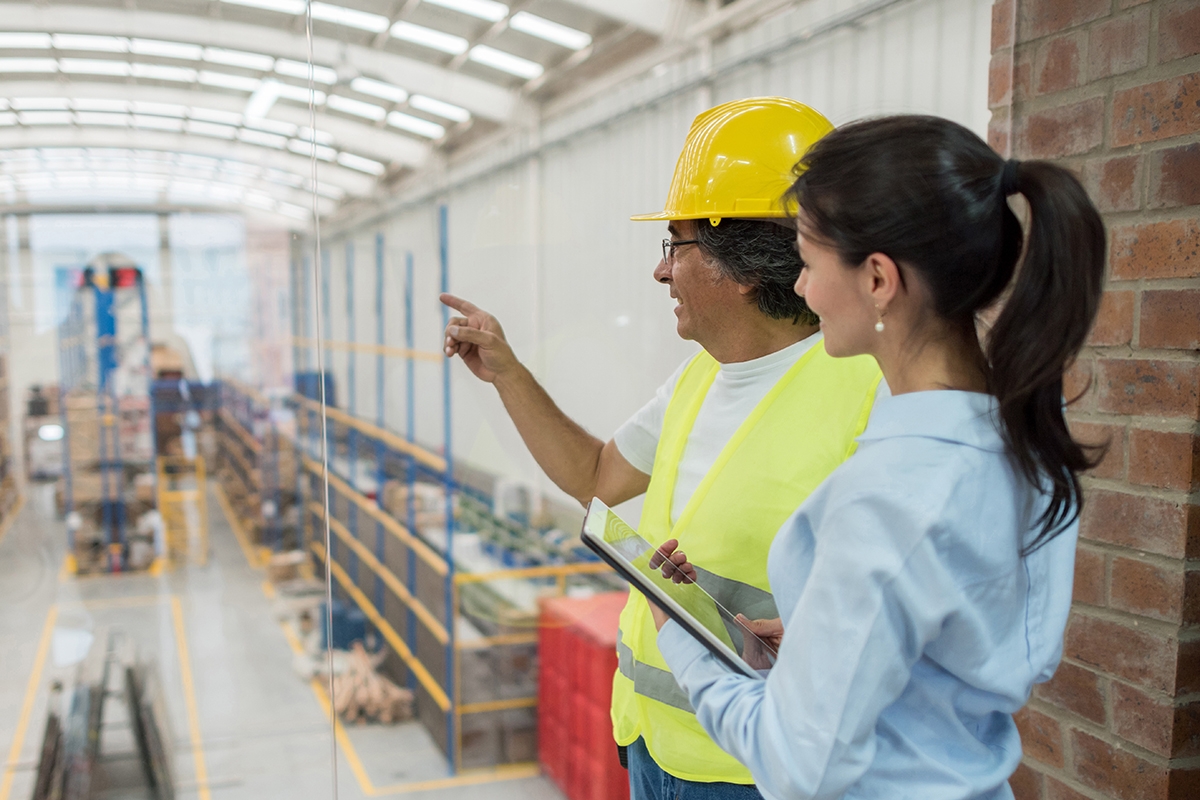 Man and Woman Looking at Warehouse