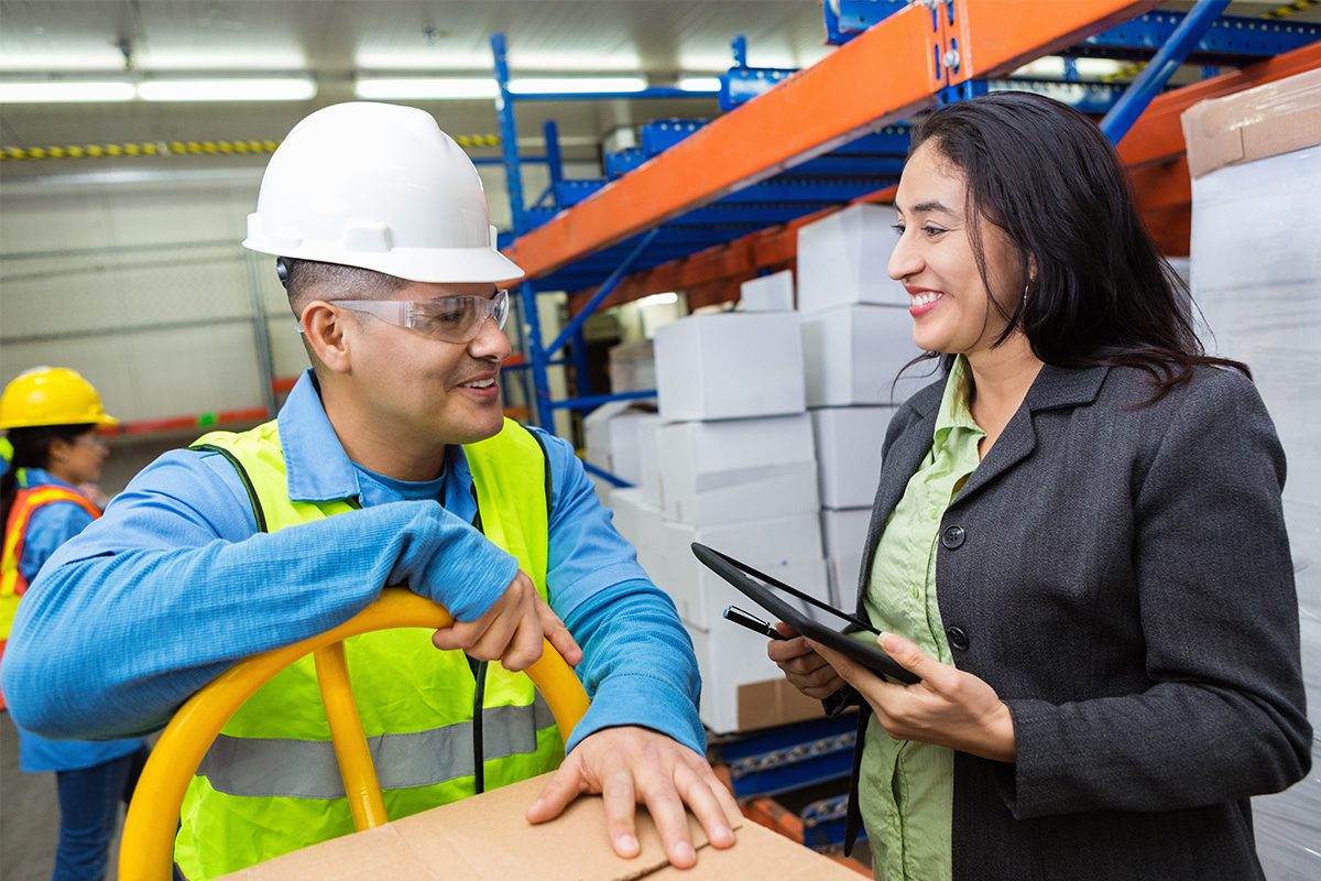 Man and Woman Talking in Warehouse