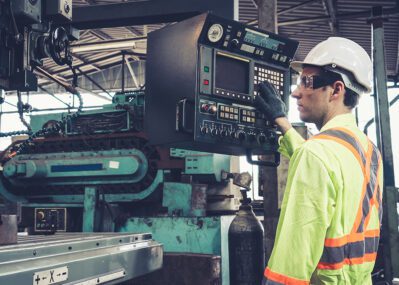 Man at Machine Control Panel