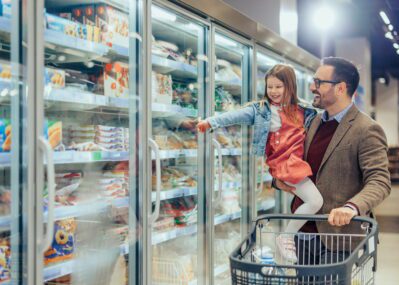 Dad and daughter buying frozen pasta