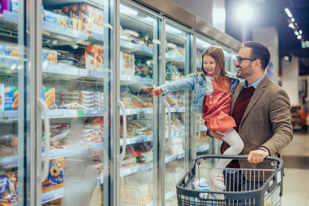 Dad and daughter buying frozen pasta